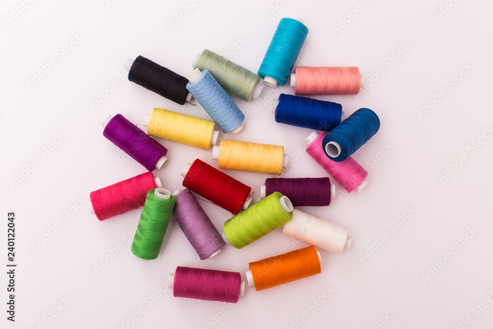 Colourful thread spools isolated on a white background Colourful thread spools isolated on a white background