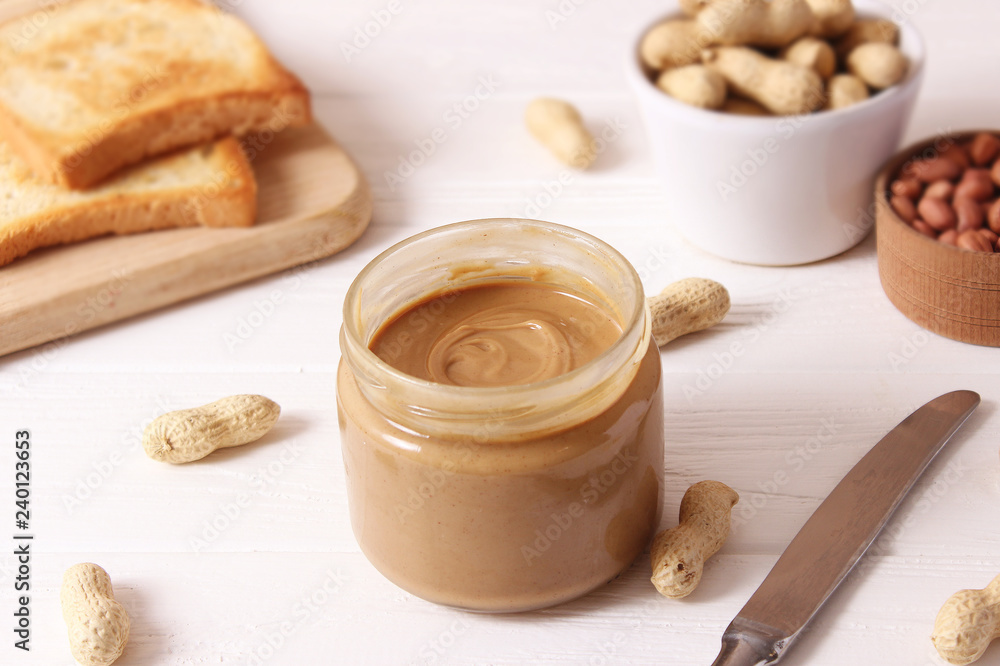 peanut butter and peanut beans on wooden background peanut butter and peanut beans on wooden background
