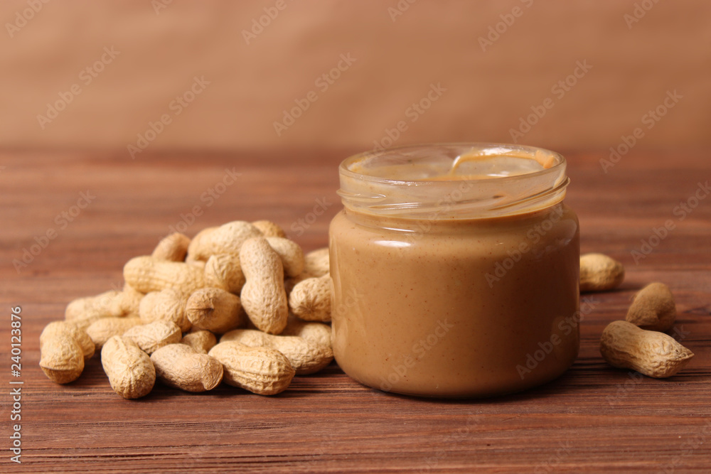 peanut butter and peanut beans on wooden background peanut butter and peanut beans on wooden background