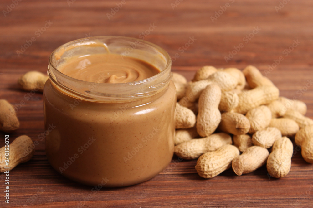 peanut butter and peanut beans on wooden background peanut butter and peanut beans on wooden background