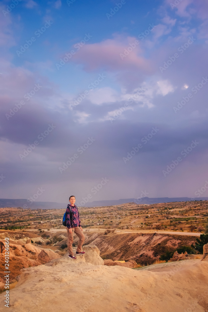 Tourist woman enjoy sunset mountain view in Cappadocia