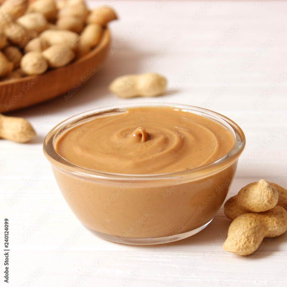 peanut butter and peanut beans on wooden background peanut butter and peanut beans on wooden background