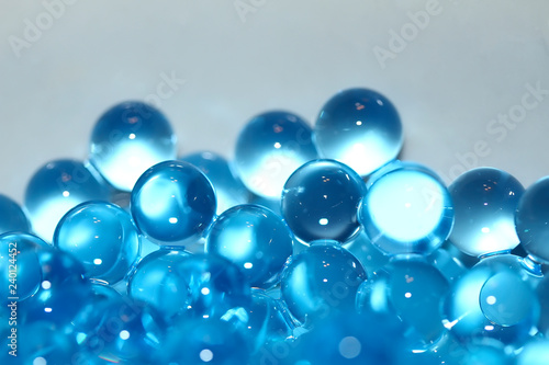 Water blue gel balls. Polymer gel. Silica gel. Balls of blue hydrogel. Crystal liquid ball with reflection. Texture background. Close up macro