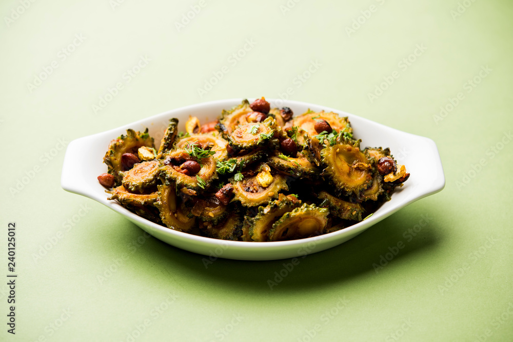 Cooked bitter Melon/gourd or Karela Sabzi served in a bowl. Scientific name of this healthy vegetable is Momordica charantia. selective focus Cooked bitter Melon/gourd or Karela Sabzi served in a bowl. Scientific name of this healthy vegetable is Momordica charantia. selective focus