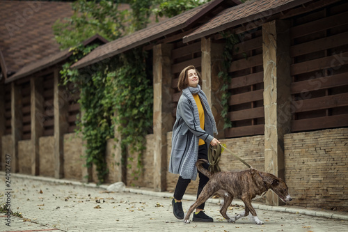 Girl walking with a dog © chumakovaslonik