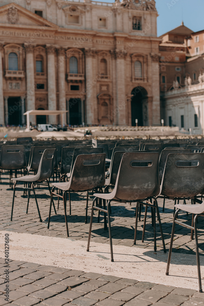 St. Peter's Square in the Vatican on a sunny day. Architecture and many chairs
