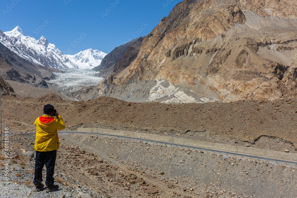 Photographer take photo at Passu Glacier. Karakorum region. Passu Peak is situated in the back side of the glacier.Northern Pakistan.