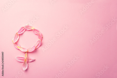 Gender Venus symbol made of beautiful flower petals on candy pink background, copy space for text photo