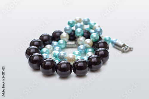 Black bracelet and white and blue necklace