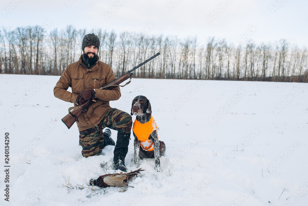 happy hunter with dog and their game. full length photo. good day for hunting. copy space. hobby, interest, lifestyle