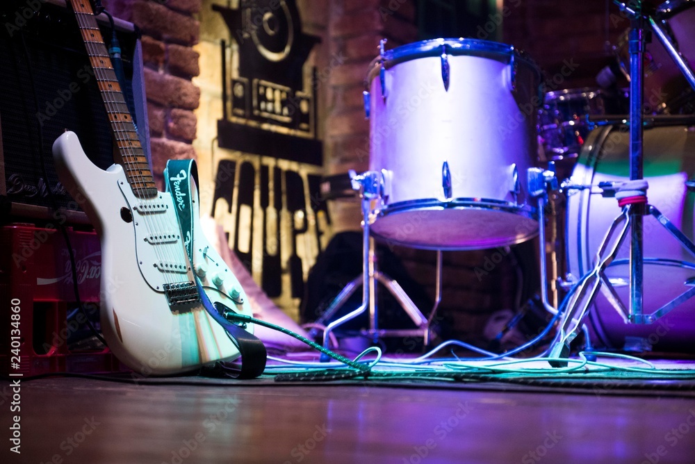 rock music stage with guitar and drums. music scene background. Stock Photo  | Adobe Stock
