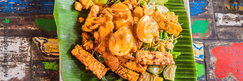 Gado-gado Indonesian salad served with peanut sauce. Ingredients: tofu, spinach, string beans, soy sprouts, potatoes, cucumber and boiled eggs BANNER, LONG FORMAT photo