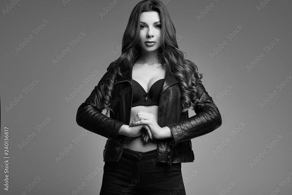 Fototapeta premium Young sexy girl with long hair in leather jacket