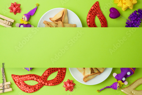 Jewish holiday Purim background with carnival mask and hamantaschen cookies.
