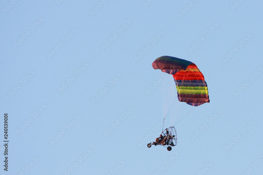 A colorful Para Plane floats through the sky A colorful Para Plane floats through the sky