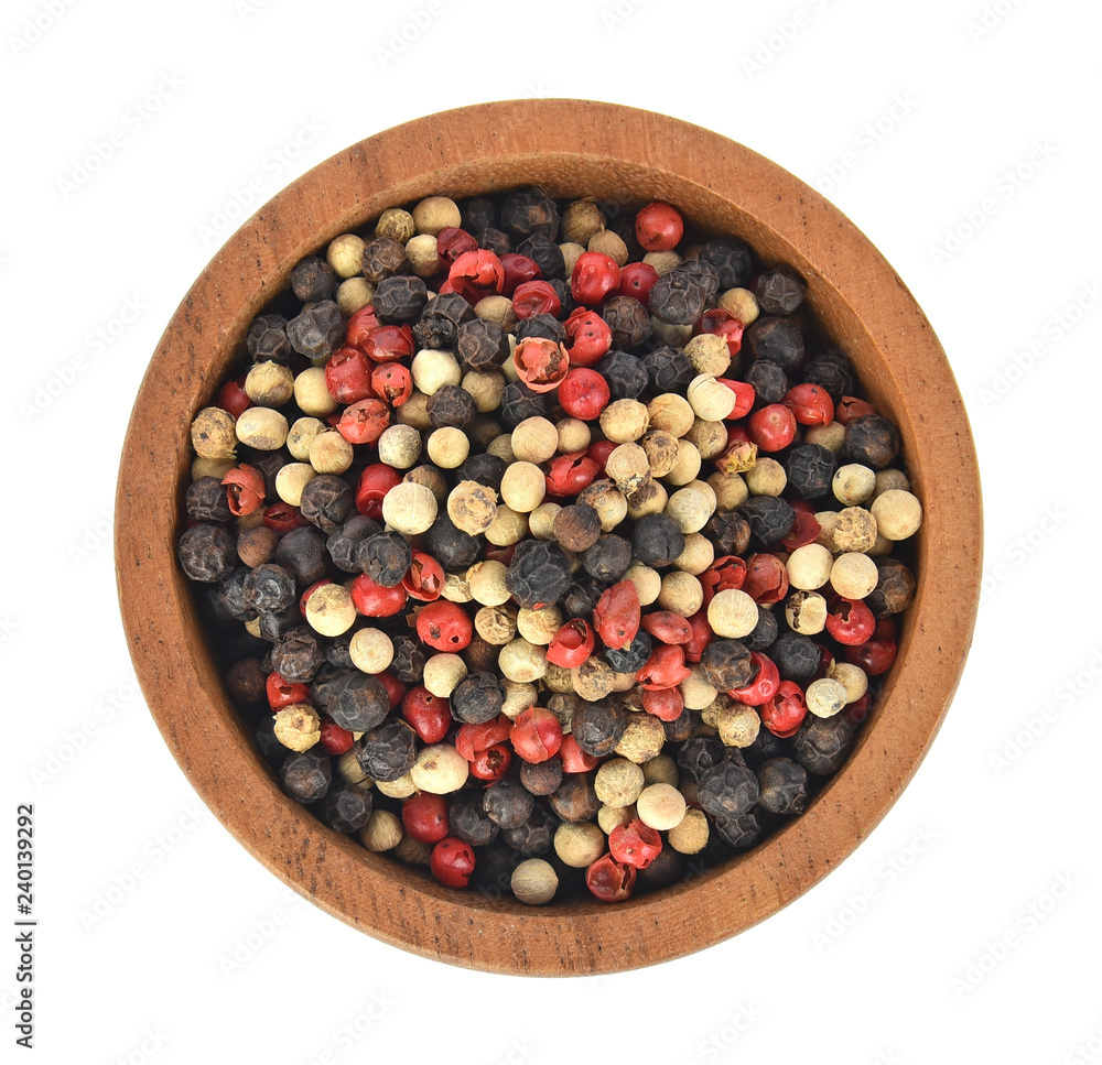 Top view of Black, red and white pepper in wooden bowl on white background Top view of Black, red and white pepper in wooden bowl on white background