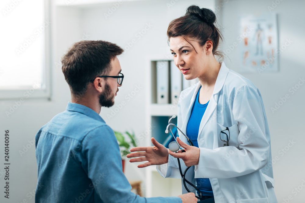Woman Doctor talking to Patient at her Medical Office Woman Doctor talking to Patient at her Medical Office