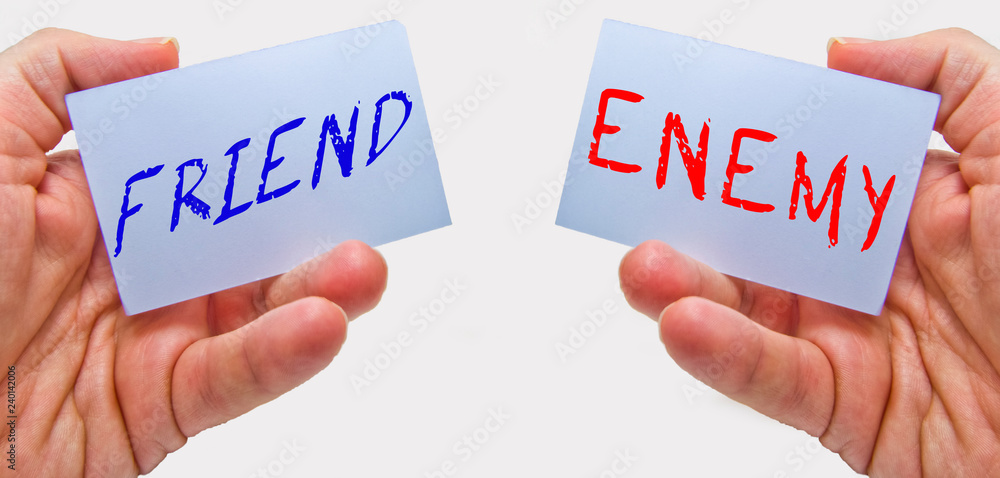 friend and enemy cards with man hands on a white background. for business and education concepts friend and enemy cards with man hands on a white background. for business and education concepts