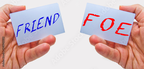 friend or foe signs on cards in man hands with a white background. for business concepts