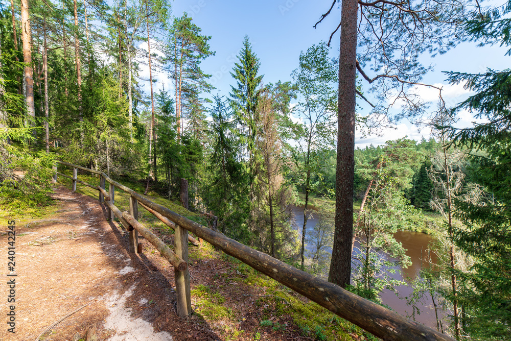 tourist trail with wooden pathwalk and stairs near sandstone cliffs tourist trail with wooden pathwalk and stairs near sandstone cliffs