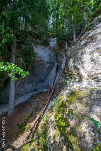 tourist trail with wooden pathwalk and stairs near sandstone cliffs