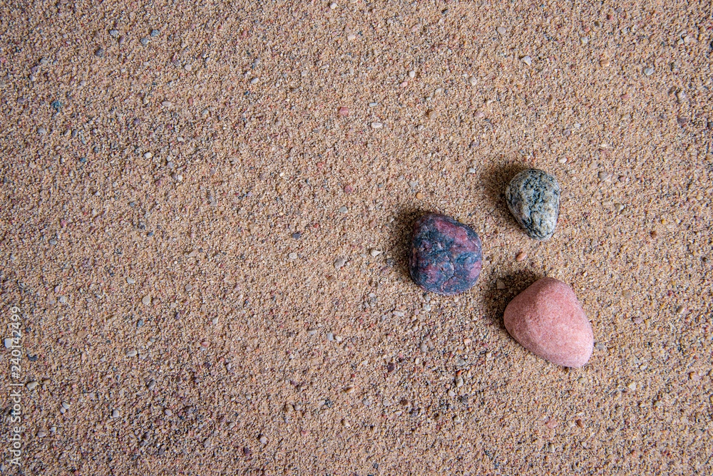 relaxing stones laying on sand textured pattern relaxing stones laying on sand textured pattern