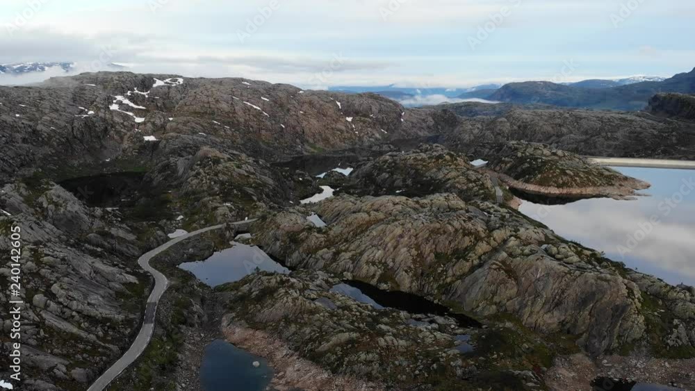 Aerial view. Road and lakes in stone rocky mountains. Norway summer landscape. Norwegian national tourist scenic route Ryfylke Aerial view. Road and lakes in stone rocky mountains. Norway summer landscape. Norwegian national tourist scenic route Ryfylke