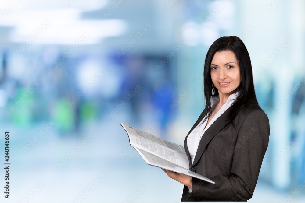 Young businesswoman in suit on blurred background