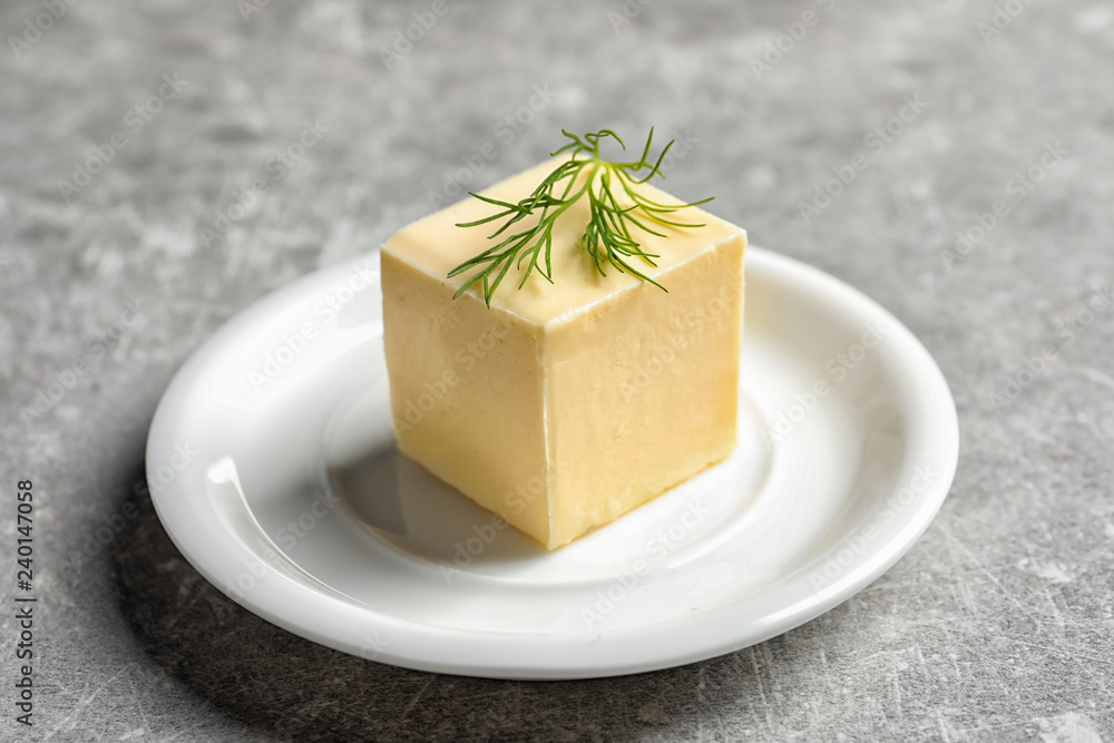 White plate with fresh butter on table White plate with fresh butter on table