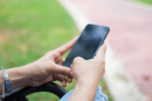 woman's hand holding smart phone with blur background. selective focus and soft focus.