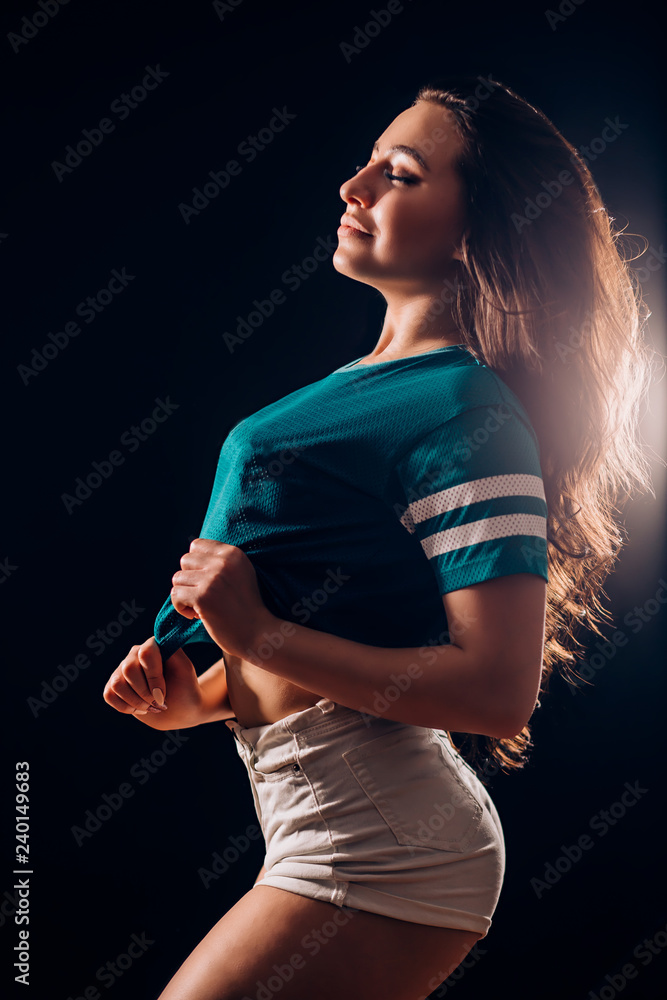 Silhouette portrait of a beautiful brunette woman sideways. Sexy girl in white  shorts and t-shirt smiles and closes her eyes. Slim figure, fitness Stock  Photo | Adobe Stock