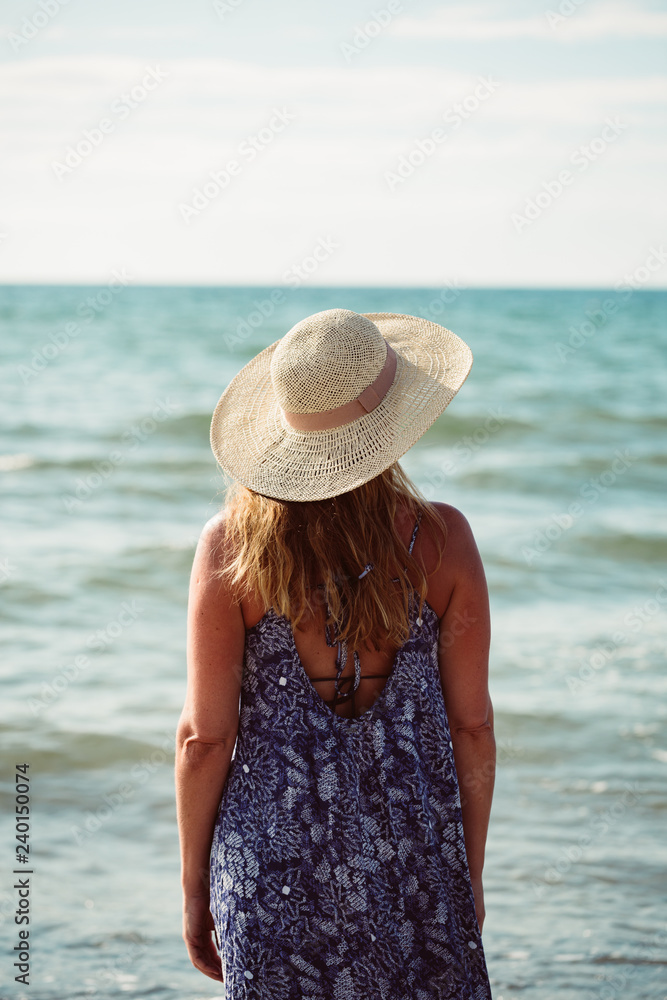 Rear view of middle aged woman on the beach