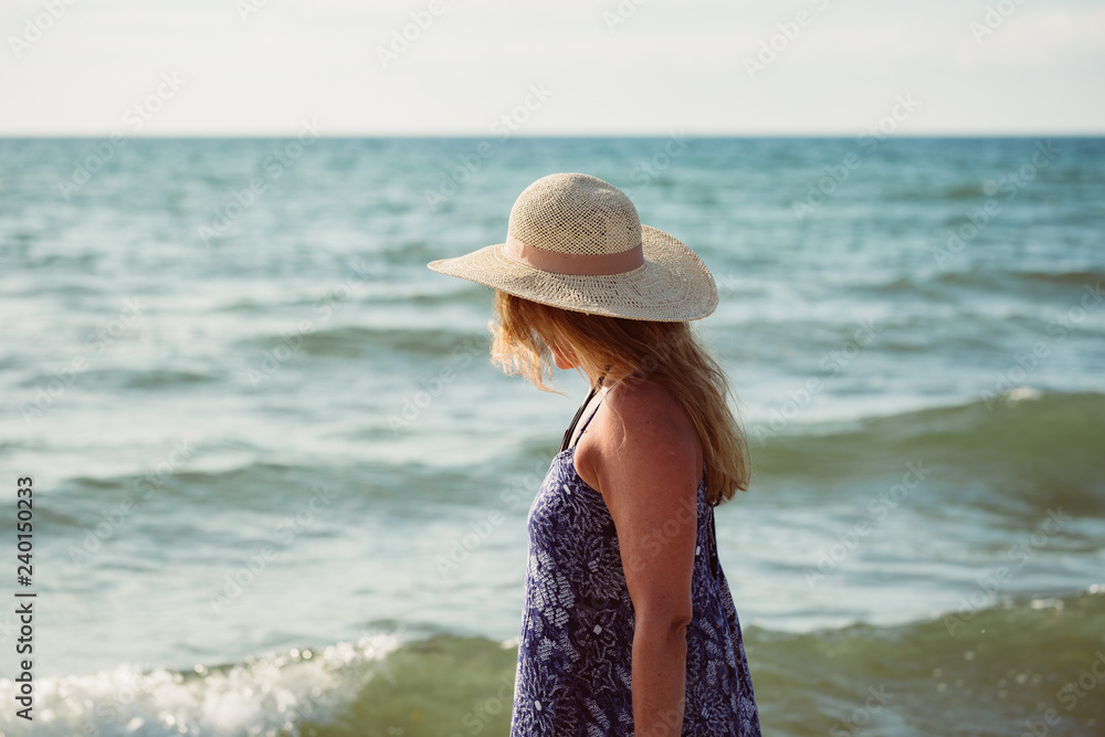 Rear view of middle aged woman on the beach