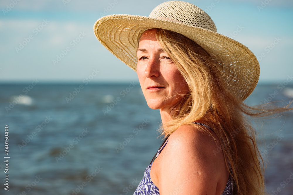 Beautiful portrait of middle aged woman on the beach