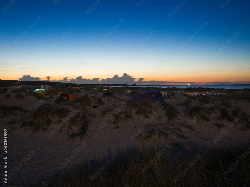 Night view of a campsite at sunset on Baltic Sea