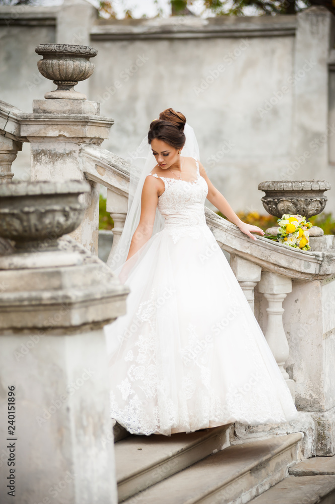 Beautiful european bride walking near old castle and have fun Beautiful european bride walking near old castle and have fun