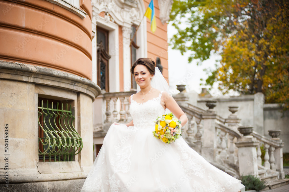 Obraz premium Beautiful european bride walking near old castle and have fun