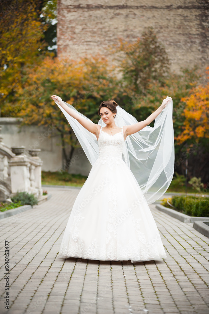 Obraz premium Beautiful european bride walking near old castle and have fun
