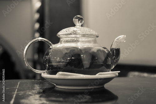 Glass teapot. Fruit and citrus tea. Hot morning drink. A warming drink with pieces of fruit. Glass teapot for tea. Beautiful tea service in the restaurant.