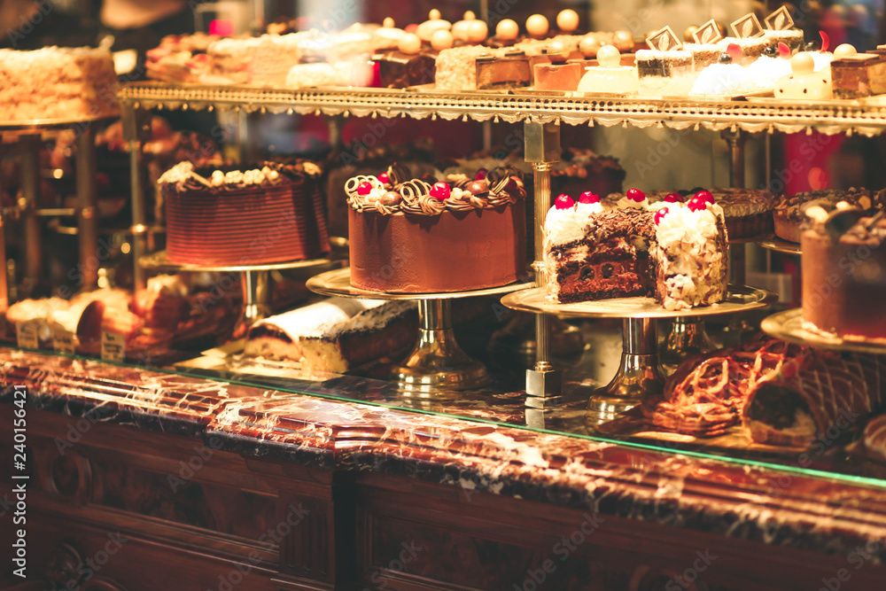 Pastry shop display window with variety of cakes