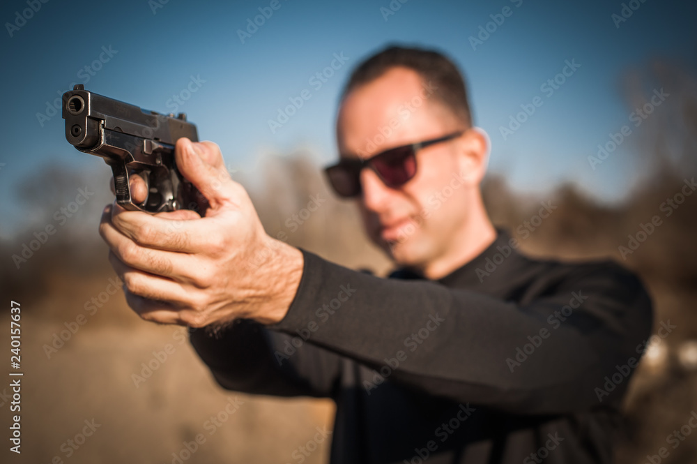 Police agent bodyguard gun pointing pistol to attacker. Front view Police agent bodyguard gun pointing pistol to attacker. Front view