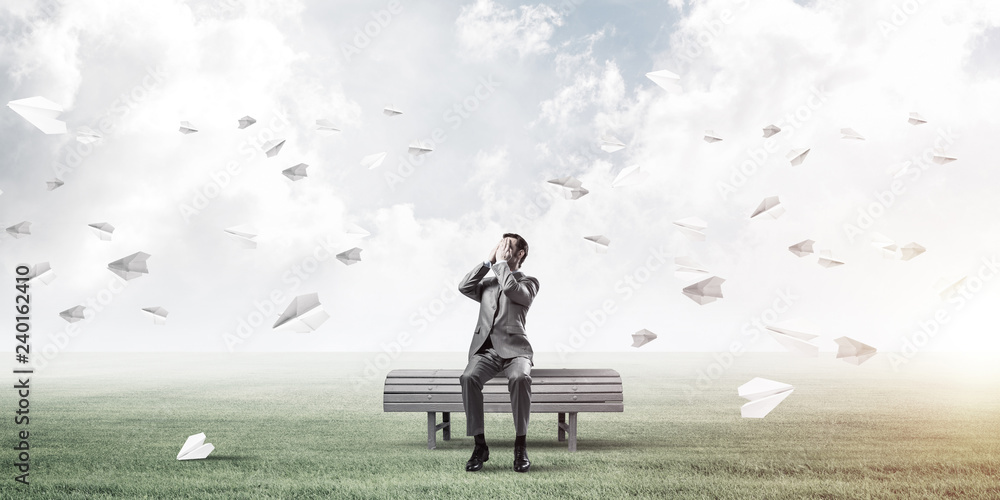 Young man in summer park on bench do not want to see anything Young man in summer park on bench do not want to see anything