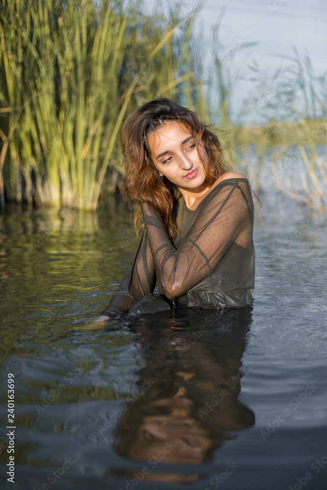 Fototapeta premium summer portrait of a swimming girl, emotional portrait of a girl in the water 