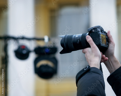 The photographer behind operation. To make a successful photo, the photographer should lift the camera over the head. Vertical photo