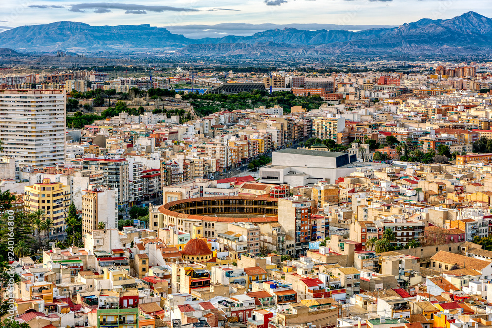 Cityscape of Alicante, its bullfighting ring and mountains in the background..