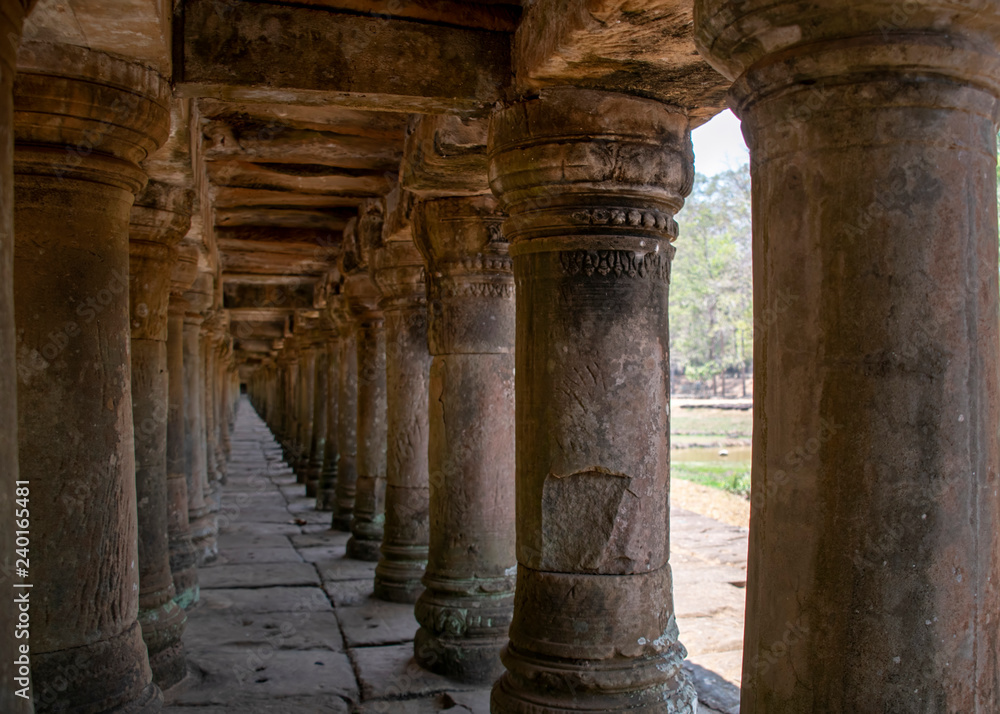 A stone causeway supported by many finely carved columns provides an impressive entrance to the Baphuon temple mountain.