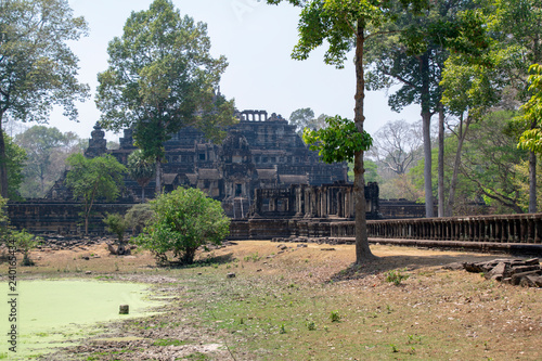 A stone causeway supported by many finely carved columns provides an impressive entrance to the Baphuon temple mountain. © CharnwoodPhoto