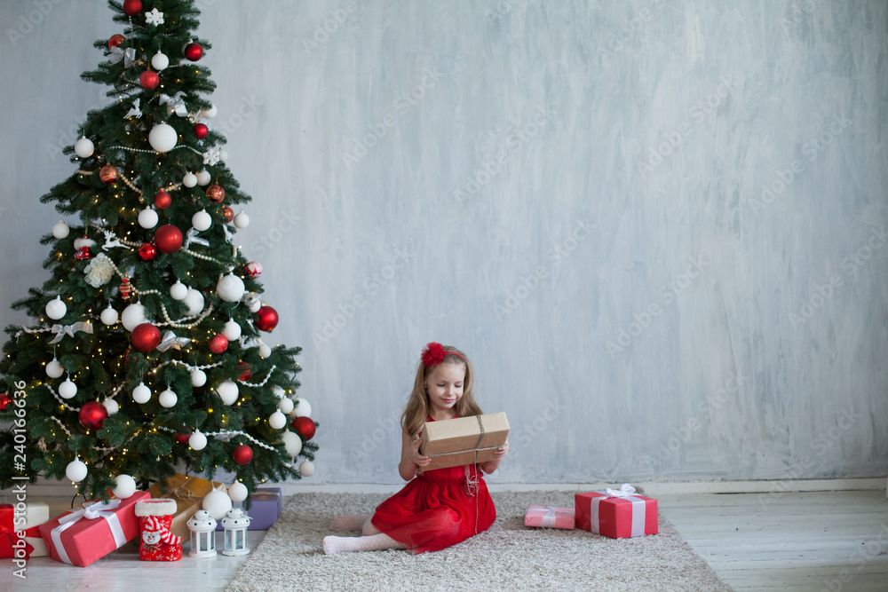 little girl opens Christmas presents new year tree little girl opens Christmas presents new year tree