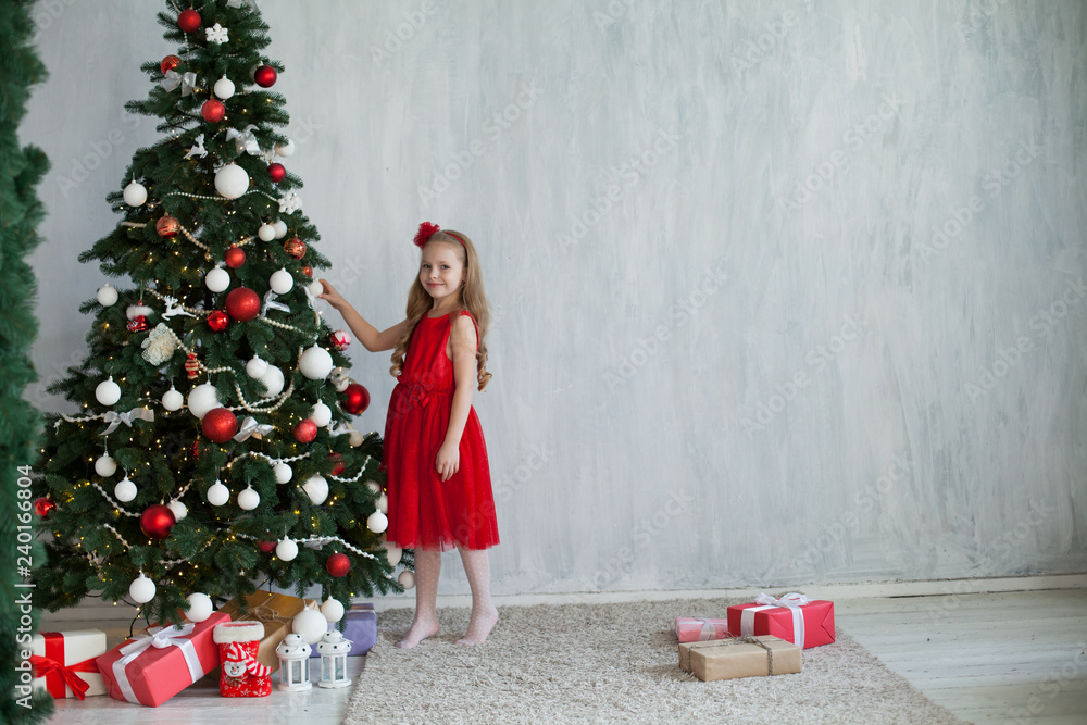 little girl opens Christmas presents new year tree little girl opens Christmas presents new year tree