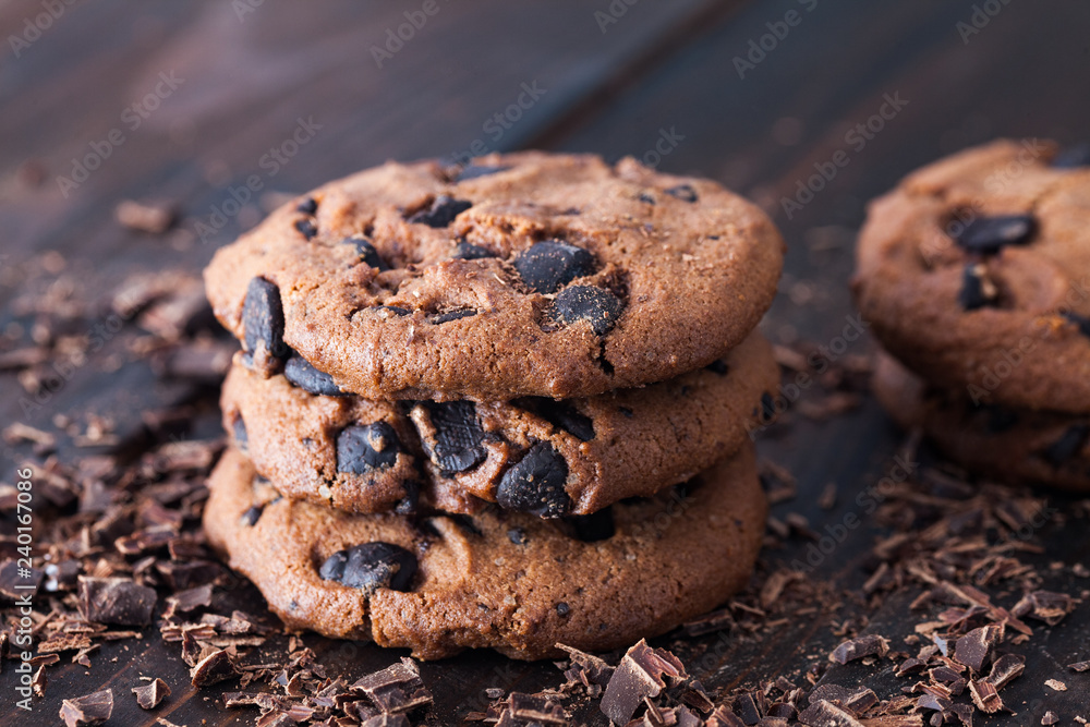 Homemade chocolate cookies on dark old wooden table. Chocolate chips cookies shot. Homemade chocolate cookies on dark old wooden table. Chocolate chips cookies shot.